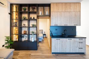 a kitchen with a sink and a room with a bed at Rezevici Horison View Apartment in Reževići