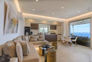 a large living room with a couch and a kitchen at LemonTree Villa Rooftop Jacuzzi And Sea Views in Skopelos Town