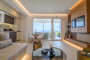 a living room with a couch and a glass table at LemonTree Villa Rooftop Jacuzzi And Sea Views in Skopelos Town