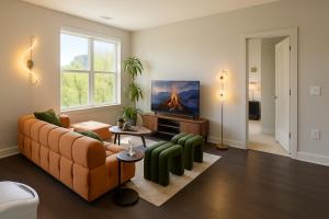 a living room with a couch and a tv at The Manor - Chevy Chase in Chevy Chase