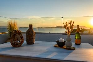 a table with several bottles and vases on it at LemonTree Villa Rooftop Jacuzzi And Sea Views in Skopelos Town +57 photos