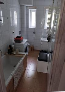 a bathroom with a bath tub and a sink at Dana in Sokołowsko