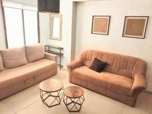 a living room with a couch and two tables at Los BOLICHES Playa in Fuengirola