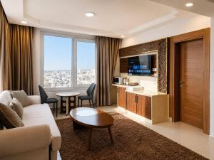 a living room with a couch and a table at Diamond Star Hotel فندق النجمة الماسية in Seeb