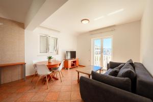 a living room with a couch and a table at Grand Holiday Residence in Komarna