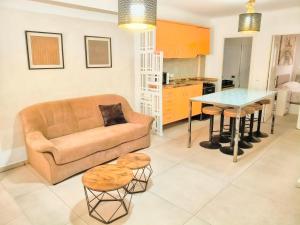 a living room with a couch and a table at Los BOLICHES Playa in Fuengirola