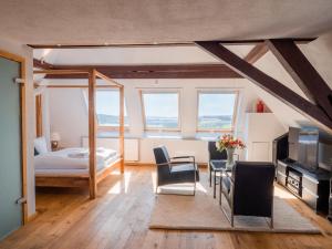 a bedroom with a bed and a table and chairs at Villa Stradivari - Black Forest with Alpine views in Lenzkirch