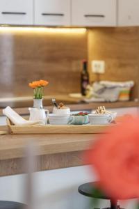 a counter in a kitchen with bowls and flowers on it at Apartments Cvelic Milovcic in Malinska +61 photos