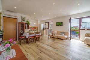 a living room with a table and a dining room at Apartments Cvelic Milovcic in Malinska
