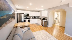 a living room with a couch and a kitchen at Bright & Cozy Private 1BR Suite in Whitehorse
