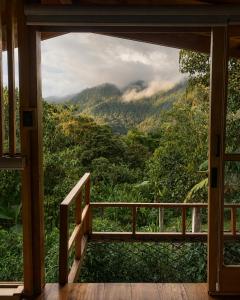 a room with a view of the mountains at MindoLoft Loft de lujo con servicio premium en Mindo in Mindo