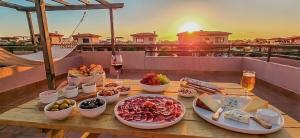 a table with food and drinks on top of a balcony at Villa Colibri Azul in Lajares +31 photos