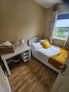 a small bedroom with a bed and a window at The Yellow Bollard in Galway