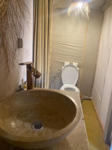 a bathroom with a sink and a toilet at Merzouga Luxury Camping in Merzouga