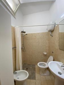 a bathroom with a toilet and a sink at Le Nuage in Torre Lapillo +32 photos