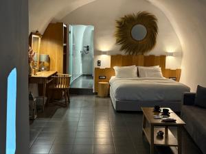 a hotel room with a bed and a bathroom at Esmi Suites Santorini in Imerovigli +111 photos