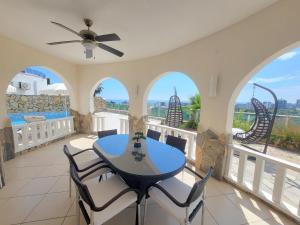 a dining room with a table and chairs on a balcony at Jasminpark Villa in Alanya