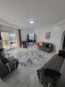 a living room with a couch and a table at Jasminpark Villa in Alanya