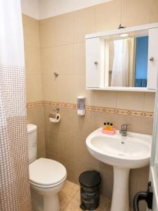 a bathroom with a sink and a toilet and a mirror at Amarildo Rooms in Durrës +44 photos