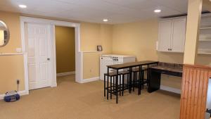 a kitchen with a counter and a table and a dishwasher at Private Two Queen Beds Room Near UPEI & Downtown Cozy Retreat Near Everything in Charlottetown