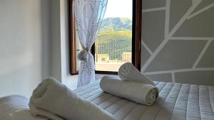 a bedroom with a bed with towels on it with a window at Balcón de Mágina in Torres +46 photos