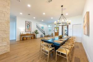 a dining room with a blue table and chairs at Waterfront Paradise Dock Pool Boathouse in Jacksonville