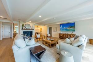a living room with two couches and a fireplace at Waterfront Paradise Dock Pool Boathouse in Jacksonville +79 photos