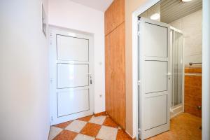 a hallway with a white door and a closet at Royal Sea Panorama in Komarna +123 photos