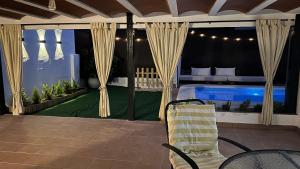 a patio with a bed and a swimming pool at Balcón de Mágina in Torres