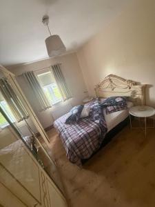 a small bedroom with two beds and a table at Dolly's Homestay in Galway