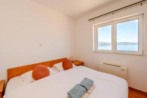 a bedroom with two beds and a window at Royal Sea Panorama in Komarna