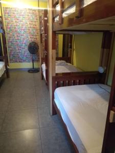 a room with two bunk beds and a fan at Cataleya BDT in Bocas Town