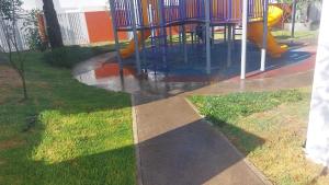 a playground with a slide in the grass at Habitaciones cómodas en Coto Galeana Guadalajara in Guadalajara