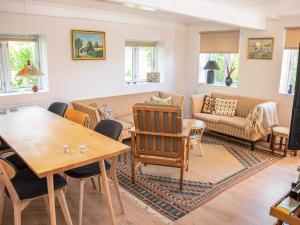 a living room with a couch and a table at Historic Gem in Samsø in Brundby