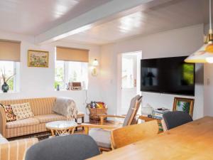 a living room with a couch and a table at Historic Gem in Samsø in Brundby
