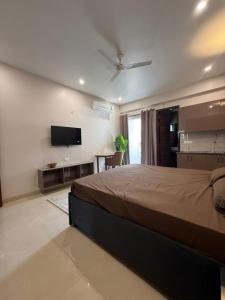 a bedroom with a bed and a flat screen tv at The Langford in Bhaktapur