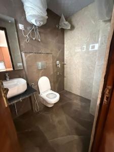 a bathroom with a toilet and a sink at The Langford in Bhaktapur
