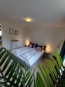 a bedroom with a bed with two lamps and a plant at Charming 2 bedroom apartment free parking in Hjørring