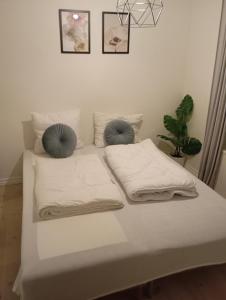 a white bed with two pillows on top of it at Charming 2 bedroom apartment free parking in Hjørring