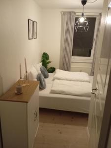 a small bedroom with a bed and a window at Charming 2 bedroom apartment free parking in Hjørring