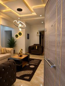 a living room with a couch and a table at Restnest suite in Benin City