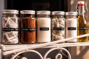 a group of jars of spices sitting on a shelf at Garden room, central Winchester in Winchester
