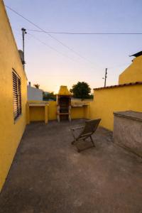 a chair sitting on the side of a building at Vivenda Santos in Albufeira