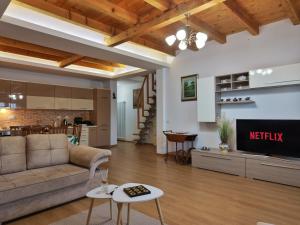 a living room with a couch and a tv at Dua 1 Apartments Shkoder in Shkodër