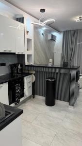 a kitchen with a black and white striped wall at Apartment Zona 0 Tulcea in Tulcea