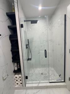 a shower with a glass door in a bathroom at The Hudson Horizon in West New York
