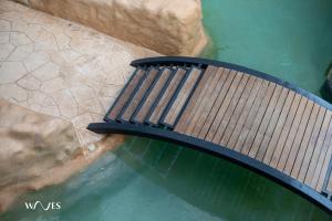 a wooden bench on a bridge over water at Spacious Loft with Balcony Near Hotel Zone Palais Tulum by Waves in Tulum