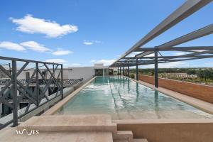 a swimming pool on the roof of a building at Spacious Loft with Balcony Near Hotel Zone Palais Tulum by Waves in Tulum