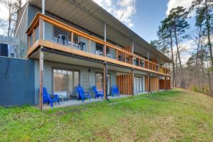 a house with a deck and blue chairs at 3-Unit Combo w/ Dock on Lake Keowee - Hike & Fish! in Seneca