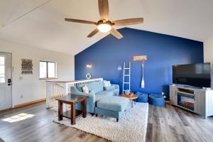 a living room with a ceiling fan and a blue wall at 3-Unit Combo w/ Dock on Lake Keowee - Hike & Fish! in Seneca